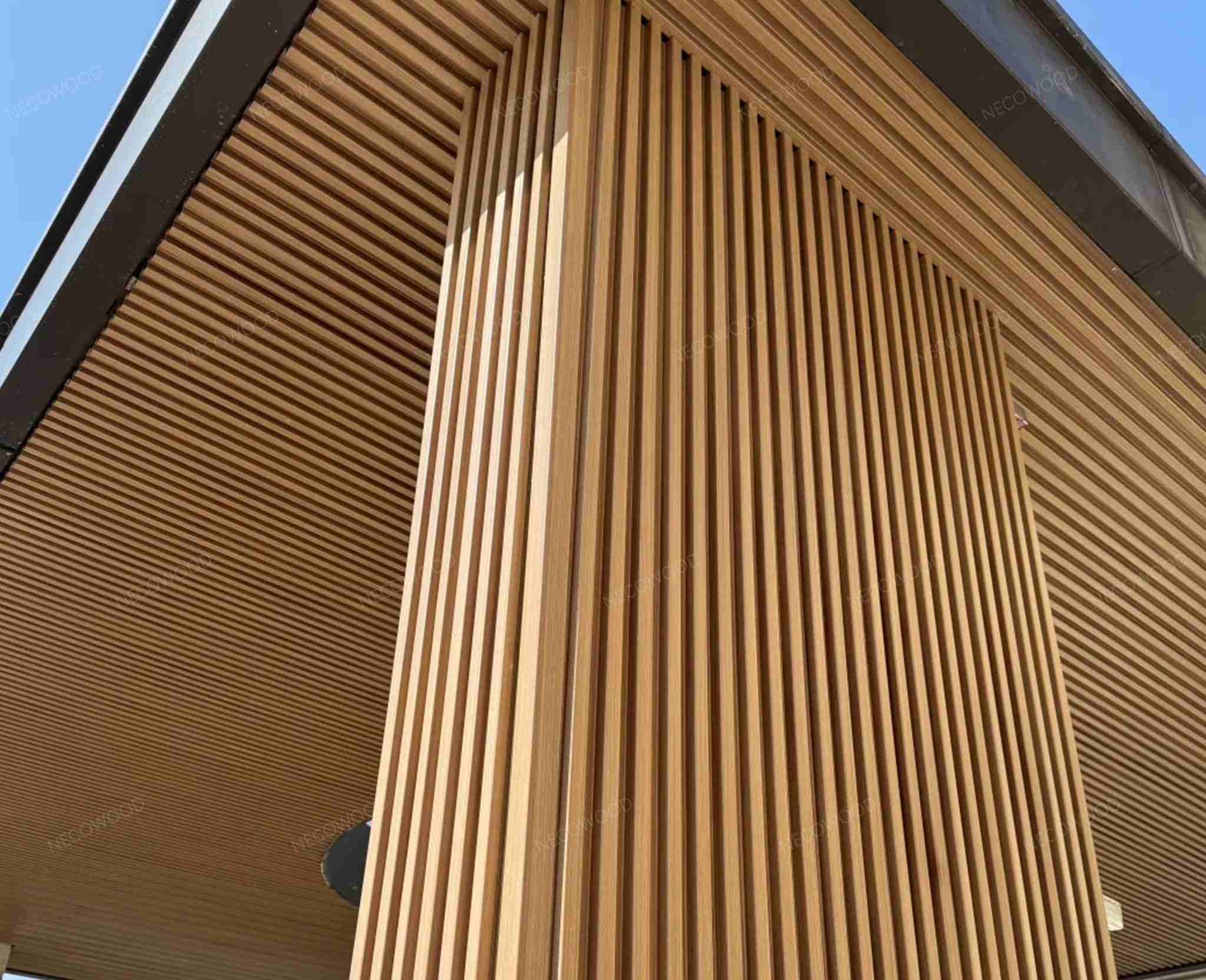 Completed outdoor building facade with WPC exterior cladding panels in New York, USA - modern unified appearance with low maintenance